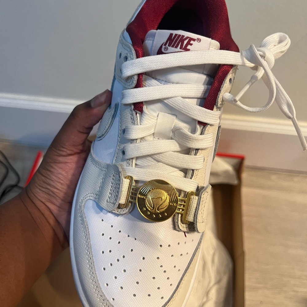 Nike White and Red Low-Top Sneaker with Gold Medallion